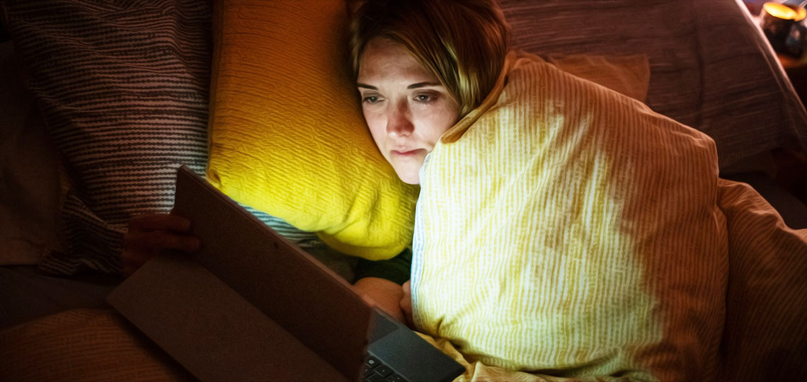 femme regarde des films sur tablette dans son lit